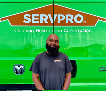 man in front of SERVPRO sign