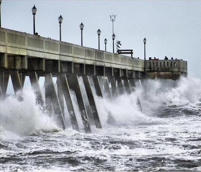Ocean waves crashing on pier