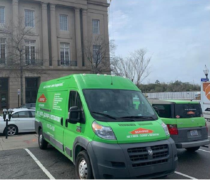 2 SERVPRO vehicles in front of a commercial property