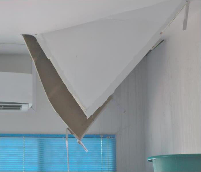 broken ceiling gypsum board from water damage