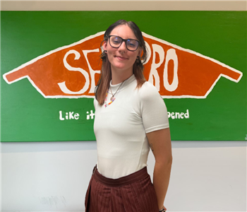 Woman in front of Servpro Sign