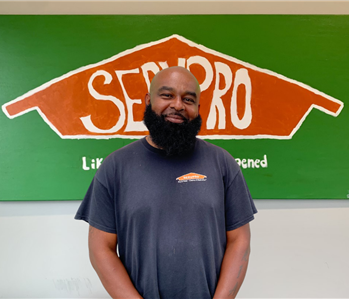 man in front of SERVPRO sign